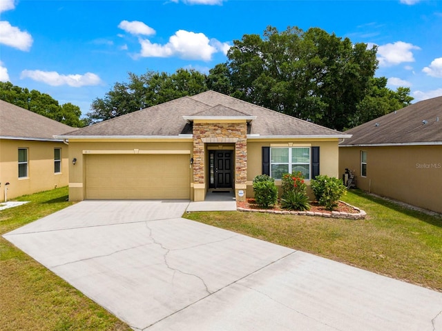 ranch-style house featuring a garage and a front yard