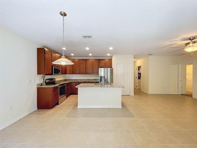 kitchen with ceiling fan, light tile floors, decorative light fixtures, stainless steel appliances, and a center island with sink