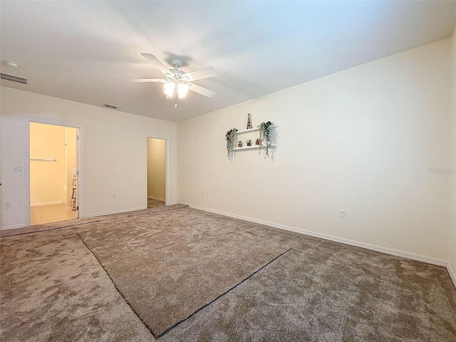 empty room with ceiling fan and carpet flooring