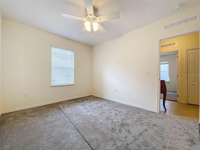 carpeted empty room with ceiling fan