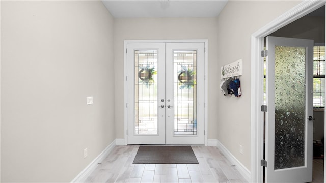 doorway featuring french doors, light hardwood / wood-style flooring, and a healthy amount of sunlight