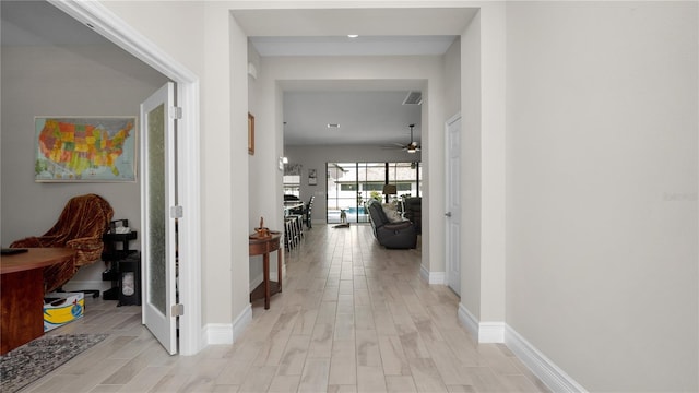 hallway with light wood-type flooring