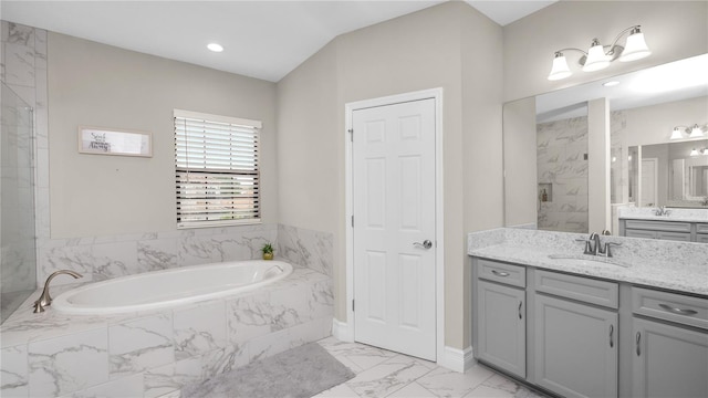 bathroom featuring separate shower and tub and vanity