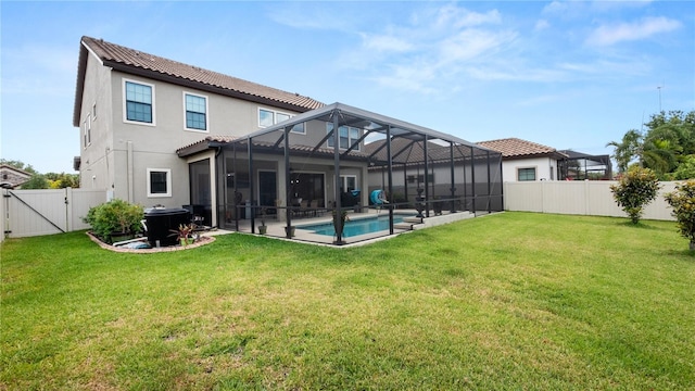 back of property with a lanai, a yard, and a fenced in pool