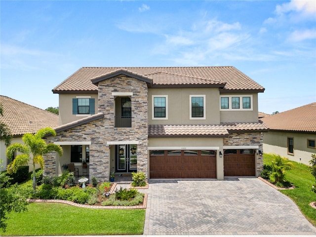 mediterranean / spanish-style house featuring a garage and a front lawn