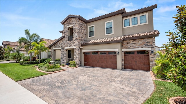 mediterranean / spanish-style house with a garage and a front lawn