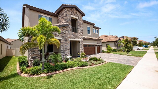 mediterranean / spanish-style house featuring a front lawn and a garage