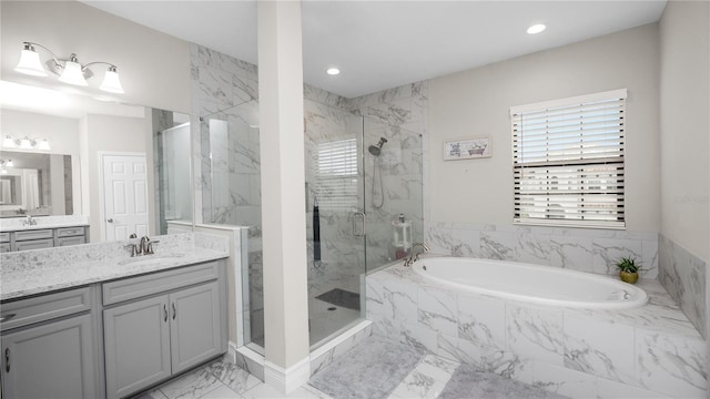 bathroom with vanity and separate shower and tub