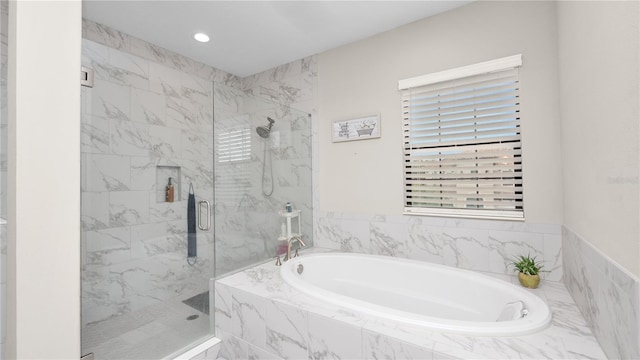 bathroom with shower with separate bathtub