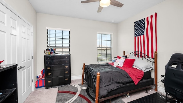 bedroom with carpet flooring, ceiling fan, and a closet