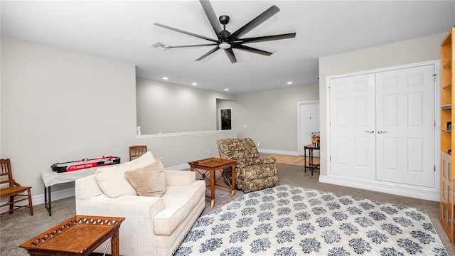 carpeted living room featuring ceiling fan