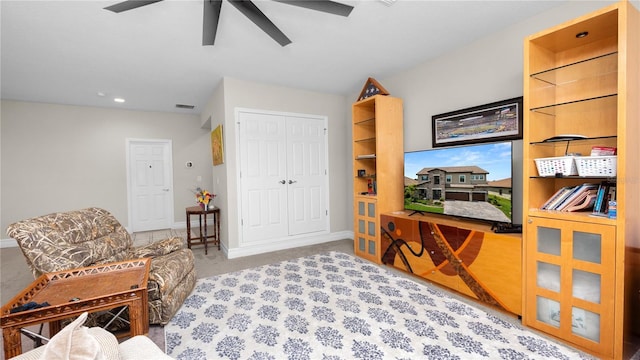 sitting room featuring ceiling fan and light colored carpet