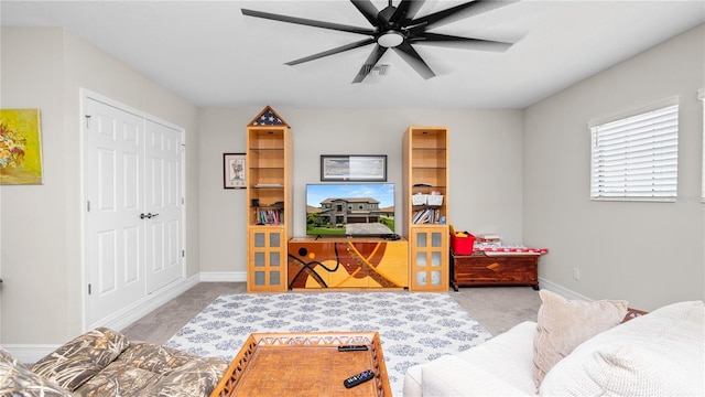 living room with ceiling fan and light colored carpet