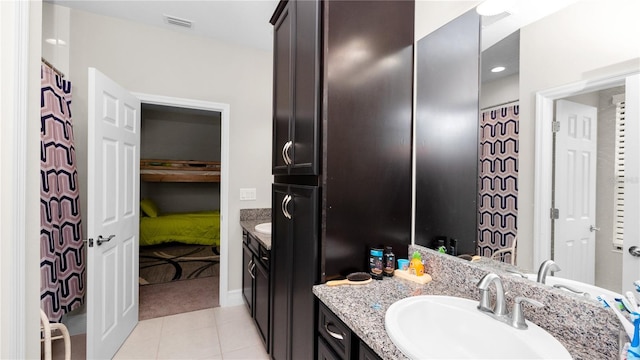 bathroom with tile patterned floors and vanity