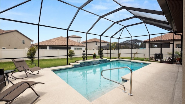 view of swimming pool featuring a patio area, a lanai, and a yard