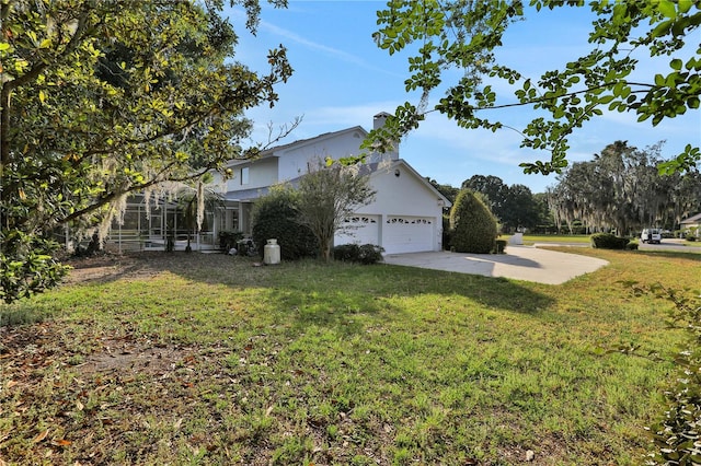 view of side of property with a lanai, a patio, a lawn, and a garage