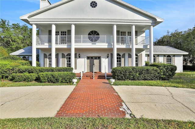 greek revival house featuring a balcony