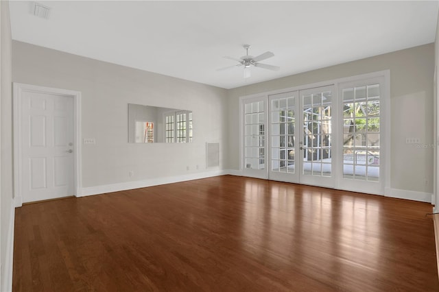 unfurnished room featuring ceiling fan and dark wood-type flooring