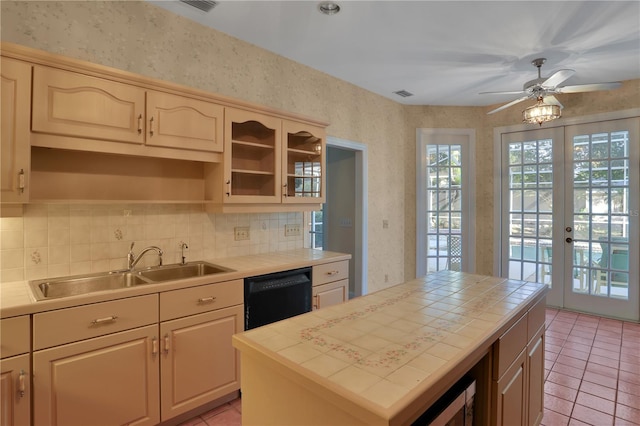 kitchen with dishwasher, a center island, french doors, light tile patterned floors, and sink