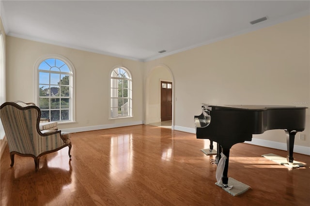 sitting room featuring light wood-type flooring and crown molding