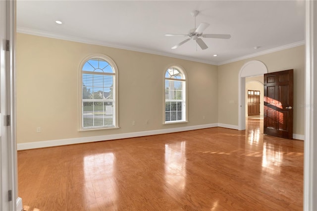 empty room featuring ceiling fan, crown molding, and light hardwood / wood-style flooring