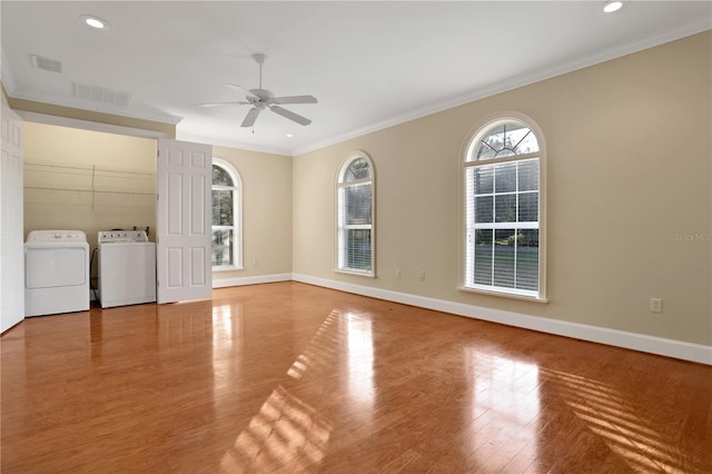 unfurnished room with washer and dryer, ceiling fan, light wood-type flooring, and crown molding