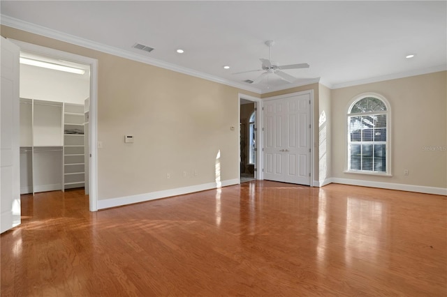 spare room featuring ornamental molding, ceiling fan, and wood-type flooring