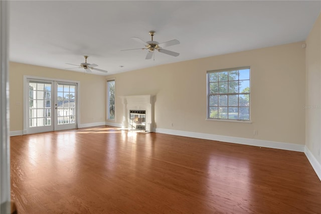 unfurnished living room featuring ceiling fan and wood-type flooring