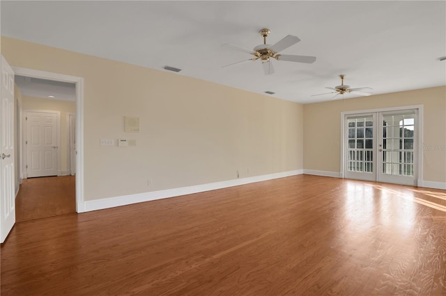 spare room featuring french doors, hardwood / wood-style floors, and ceiling fan