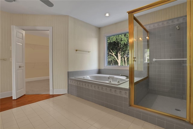 bathroom with tile patterned flooring and shower with separate bathtub