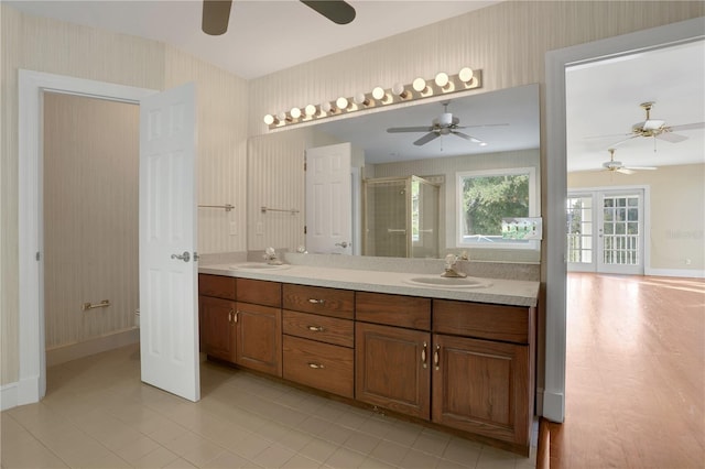 bathroom featuring french doors, tile patterned flooring, toilet, a shower with door, and vanity