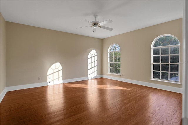 spare room with ceiling fan and hardwood / wood-style flooring