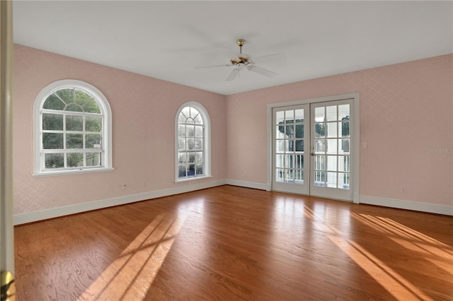 empty room featuring french doors, ceiling fan, and hardwood / wood-style floors