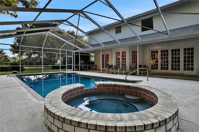 view of pool with a lanai, a patio area, french doors, ceiling fan, and an in ground hot tub