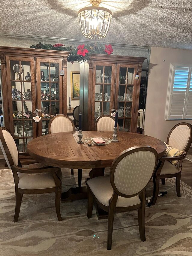 dining space with a notable chandelier and a textured ceiling