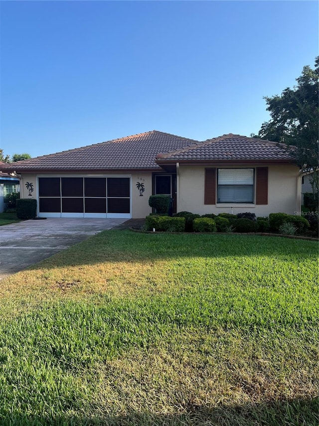 single story home with a front lawn and a garage