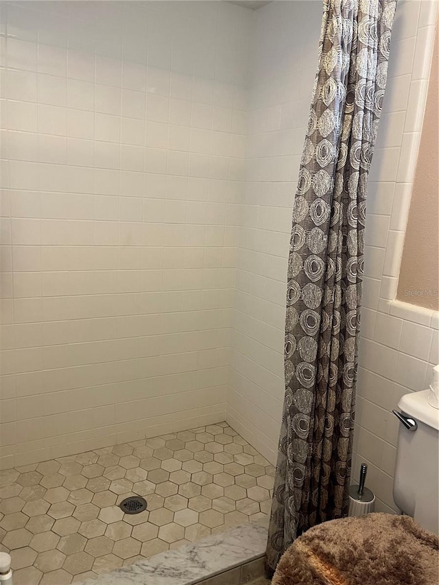 bathroom featuring walk in shower and tile walls