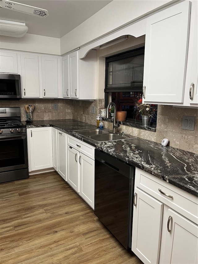 kitchen featuring decorative backsplash, sink, white cabinets, and appliances with stainless steel finishes