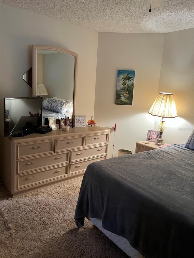 carpeted bedroom featuring a textured ceiling