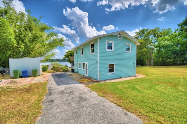 view of property exterior with a yard