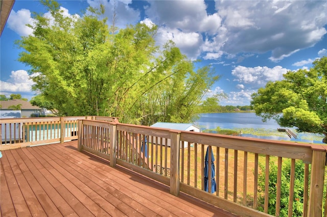 wooden terrace featuring a water view