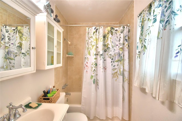 full bathroom featuring vanity, shower / bath combo, and toilet