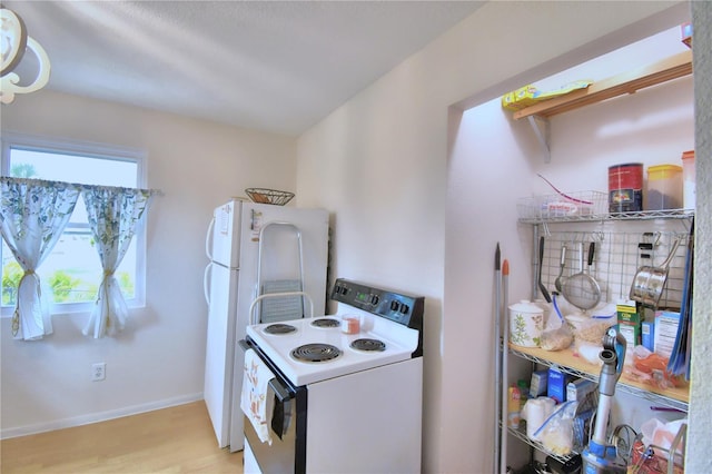 kitchen with light wood-type flooring and electric stove