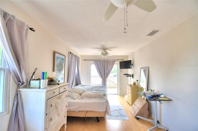 bedroom featuring ceiling fan, light wood-type flooring, and access to outside