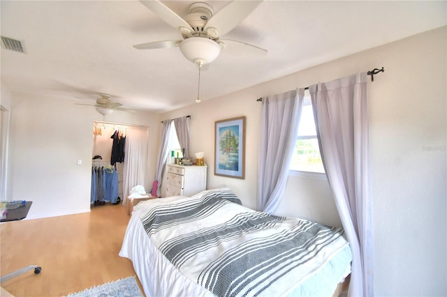 bedroom with a closet, ceiling fan, and hardwood / wood-style flooring