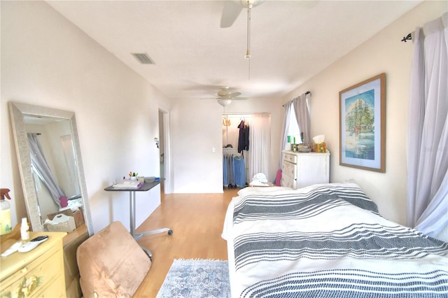 bedroom featuring a closet, ceiling fan, and light wood-type flooring