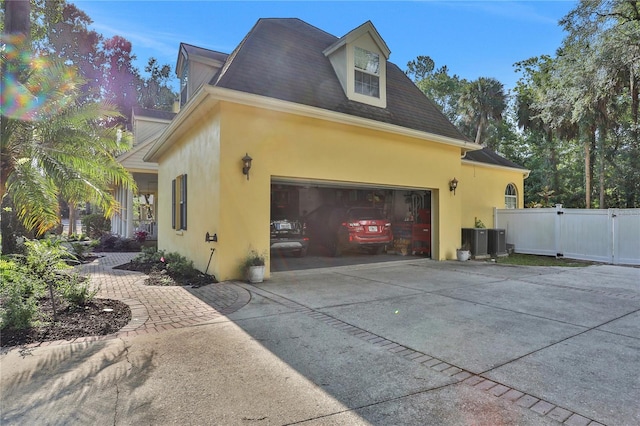 8608 Poinsettia Dr, Temple Terrace, FL 33637 - view of side of home with a garage and central air condition unit