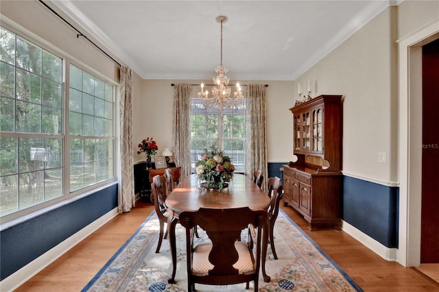 8608 Poinsettia Dr, Temple Terrace, FL 33637 - dining area featuring a chandelier, crown molding, and light wood-type flooring