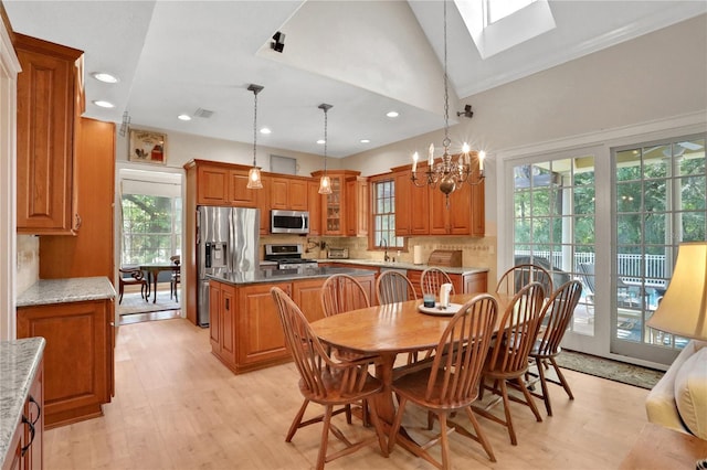 8608 Poinsettia Dr, Temple Terrace, FL 33637 - kitchen with a skylight, appliances with stainless steel finishes, light hardwood / wood-style flooring, and a wealth of natural light