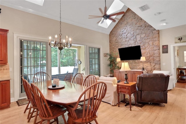 8608 Poinsettia Dr, Temple Terrace, FL 33637 - dining space with ceiling fan with notable chandelier, high vaulted ceiling, light hardwood / wood-style floors, and a skylight